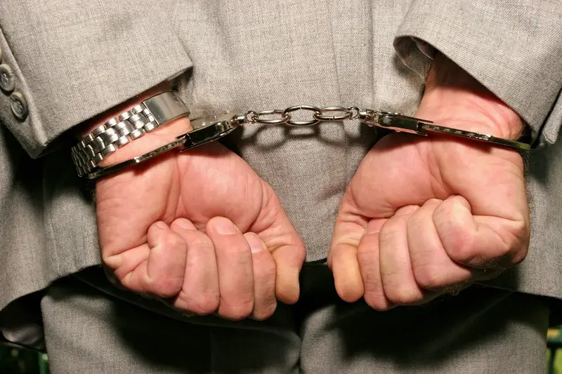 Former President is Jailed For 25 Years (handcuffs dreamstime_s_1688192)